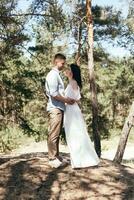 Wedding walk in the pine forest. Sunny day. photo