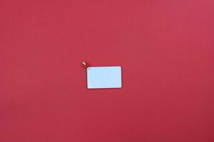 White card on red background. Copy space. Place for text. Minimalism. photo