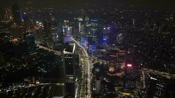 Semanggi, Jakarta, 2023 - Aerial drone view ofJakarta Night with cityscape sky scrapper and building taken with moving backward movement while revealing the city view video