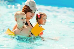 mother and children in the pool photo