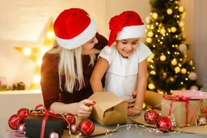 holidays, presents, christmas, x-mas, birthday concept - happy mother and child girl with gift box photo