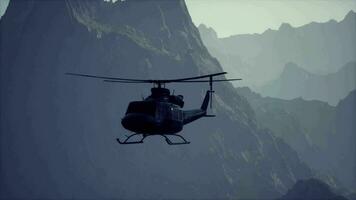 A helicopter flying over a mountain in the sky video