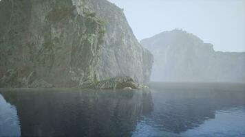 A solitary rock standing in the midst of a tranquil lake video