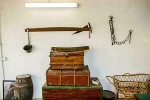 a room with a chest of drawers, a trunk and a rope photo