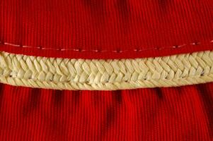 a close up of a red dress with a gold trim photo