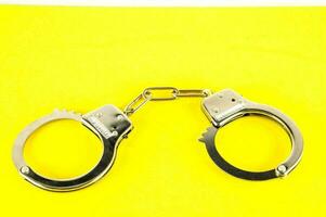 handcuffs on a yellow background photo