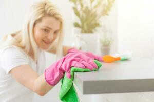 Young woman doing housework, cleaning the kitchen photo