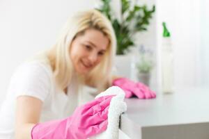 Young woman doing housework, cleaning the kitchen photo