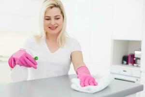 beautiful girl cleans the surface photo