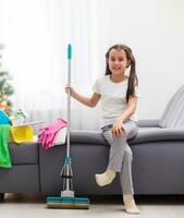 Little housekeeping fairy girl doing home chores photo