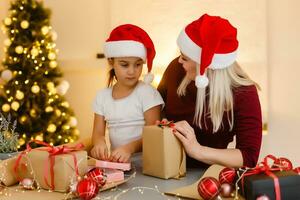 holidays, presents, christmas, x-mas, birthday concept - happy mother and child girl with gift box photo