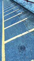 Empty parking space for motorbikes and bicycles with yellow lines. Automobile parking garage at office area parking lot photo