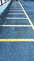 Empty parking space for motorbikes and bicycles with yellow lines. Automobile parking garage at office area parking lot photo