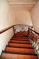 an interior architecture of downstairs with railings made of wood photo