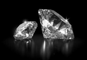 Two Diamonds in Brilliant Cut on Black Background photo