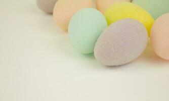 Multicolored decorative eggs on a white background. Happy Easter. Place for text. Festive background. photo