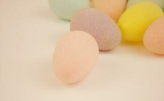 Multicolored decorative eggs on a white background. Festive background. Place for text. Happy Easter. photo