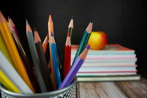 Pencils on a background of books and apples. Back to school concept. Background for design photo