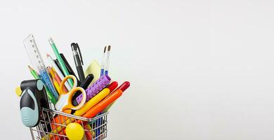 Stationery in a shopping cart. Copy space. Back to school photo