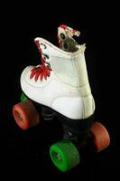 a pair of roller skates with green and red wheels photo