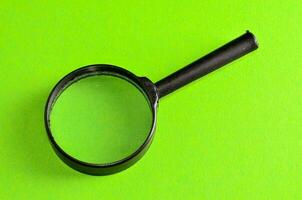 a magnifying glass on a green background photo