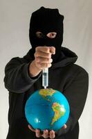 a man in a black mask holding a globe photo