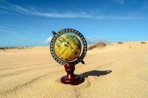 a globe in the desert photo