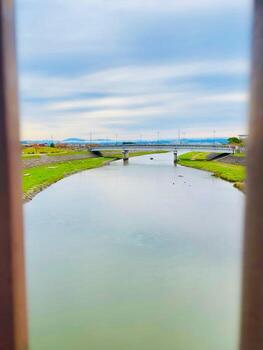 the weather in the morning with a view of a small river and slightly shy sunlight photo