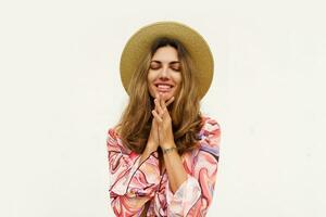 Beautiful european woman in stylish summer outfit and straw hat posing on white background. Fashion look. photo