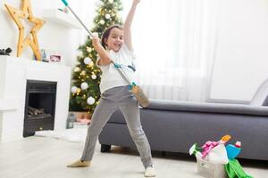 little girl cleaning the apartment before christmas photo