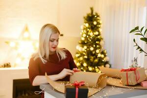 Closeup on table where woman making Christmas decorations. Upper view photo