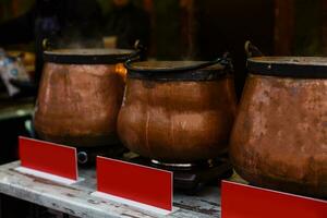 A giant pot full of hot mulled red wine with spices on the Advent Christmas market photo