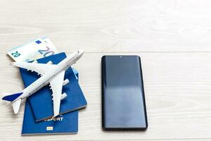 Mockup image of mobile smartphone , airplane and check book isolated on white background. Business technology trip and travel,paycheck concept. photo