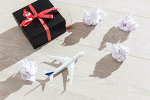 Flat lay composition with toy airplane, passport and t paper balls photo