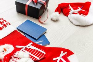 Christmas airplane travel concept. Passports, toy white plane. on gray textured background. Gift box photo