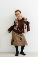 Portrait of little funny girl dressed like an old witch posing with broom in front of White background photo