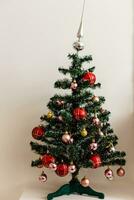 decorated mini christmas tree in the apartment photo