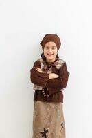 Portrait of little funny girl dressed like an old witch posing with broom in front of White background photo