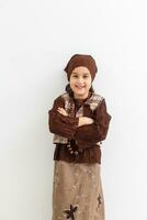 Portrait of little funny girl dressed like an old witch posing with broom in front of White background photo