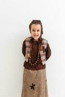 Portrait of little funny girl dressed like an old witch posing with broom in front of White background photo