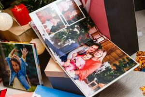 book together near Christmas tree in front of fireplace photo