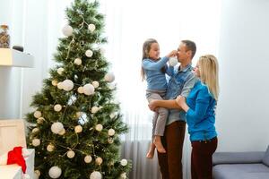 Young family on Christmas morning exchanging presents and enjoying their time together. photo