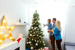 Young family on Christmas morning exchanging presents and enjoying their time together. photo