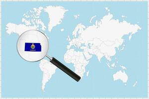 Magnifying glass showing a map of Kansas on a world map. vector