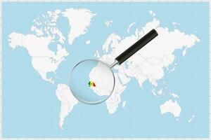 Magnifying glass showing a map of Senegal on a world map. vector