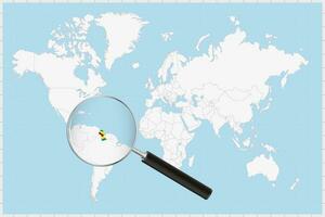 Magnifying glass showing a map of Guyana on a world map. vector