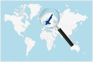 Magnifying glass showing a map of Finland on a world map. vector