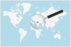 Magnifying glass showing a map of North Macedonia on a world map. vector