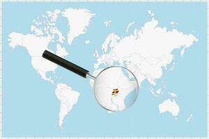 Magnifying glass showing a map of Uganda on a world map. vector