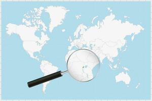 Magnifying glass showing a map of Rwanda on a world map. vector